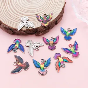 Detailed view of colorful printed hummingbird charms for DIY jewelry making.