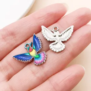 Close-up of colorful hummingbird charm and silver base for DIY jewelry making