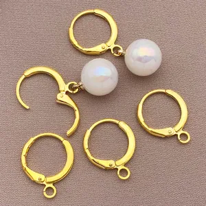 Close-up detail of 18k gold plated leverback earring hooks with iridescent white pearls