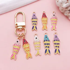 Detailed macro shot of colorful enamel koi fish charms for DIY jewelry and keychain making