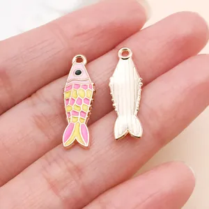 Detail showing front and back of colorful enamel koi fish charm for DIY jewelry