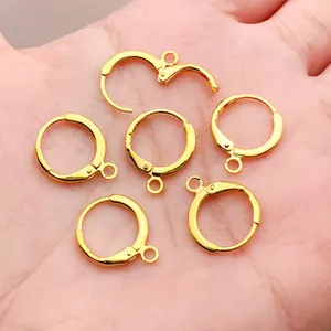 Detail view of high-quality 18k gold plated lever back earring hoops held in a hand