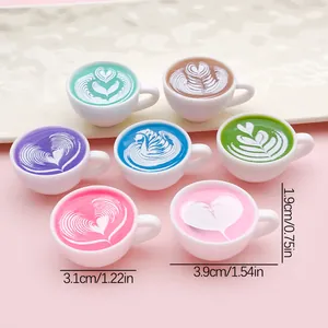 Detail of miniature resin coffee cups with colorful latte art patterns and size info.