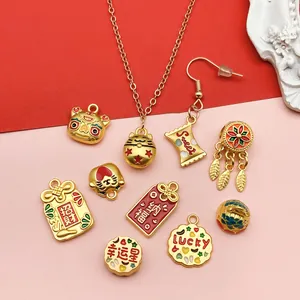 Detailed view of various gold-plated lucky cat and fortune charms for DIY jewelry making