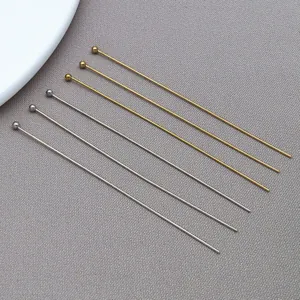 Detailed view of silver and gold stainless steel ball head pins for jewelry DIY