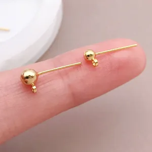 Close-up detail of 18k gold plated copper earring posts featuring a ball and loop design