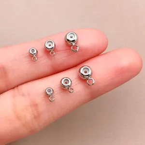 Vista detallada de cuentas plateadas con anillas y núcleo de silicona para manualidades DIY