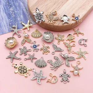 Close-up of ocean-themed zinc alloy charms with rhinestones and pearls for DIY crafts