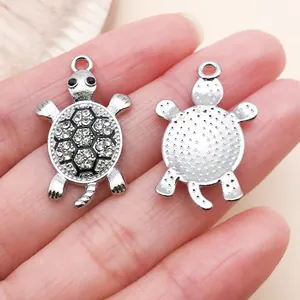 Detailed front and back view of silver turtle charm with sparkling rhinestones