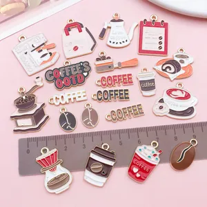 Detailed assortment of 20 coffee-themed enamel charms displayed with a metric ruler
