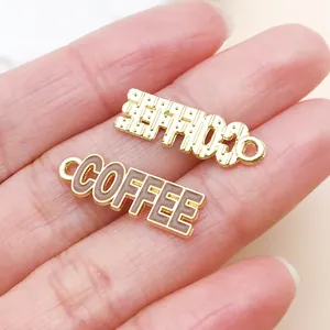 Macro detail of a golden COFFEE enamel charm for DIY jewelry making and accessories