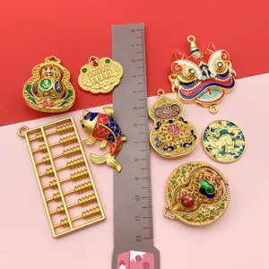 Detail view of ancient gold Chinese style pendants with ruler for size reference.