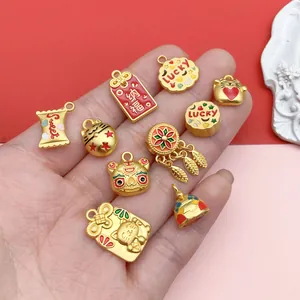 Detailed view of colorful enamel lucky cat and red envelope charms for DIY jewelry.