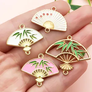 Detail view of colorful enamel fan charms for DIY jewelry and hair accessories