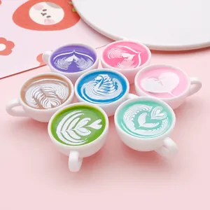Close-up detail of miniature resin coffee cups featuring colorful rainbow latte art designs