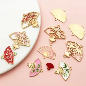 Detailed view of traditional Chinese style fan charms with bamboo and floral motifs.