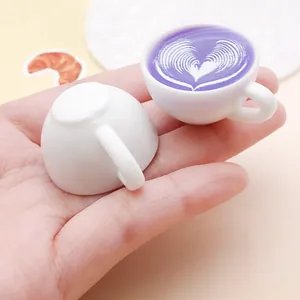 Close-up detail of miniature resin coffee cups featuring purple heart latte art for DIY crafts