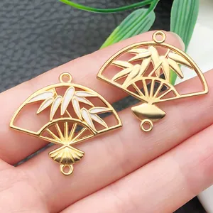 Detailed view of golden fan-shaped bamboo charms for DIY jewelry making and accessories