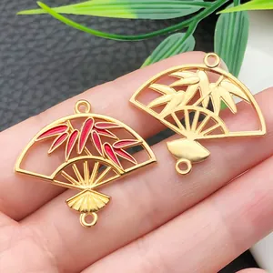 Detailed view of traditional Chinese style bamboo leaf fan charms with red enamel finish