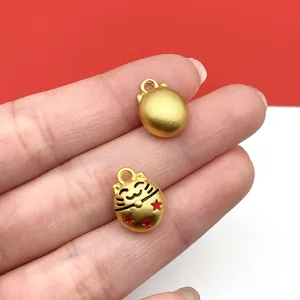 Detailed view of a gold lucky cat pendant with red stars for DIY jewelry
