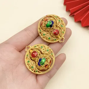 Detailed view of traditional ancient gold style round gourd pendants with colorful enamel inlay