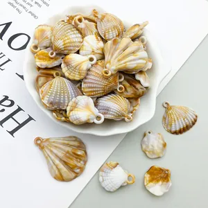 Close-up of acrylic shell and scallop charms with natural brown texture for DIY craft projects