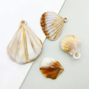 Detailed view of assorted acrylic shell charms in natural brown and beige patterns.