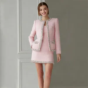 Elegant high-end pink tweed two-piece suit set with sequin trim detail on a model