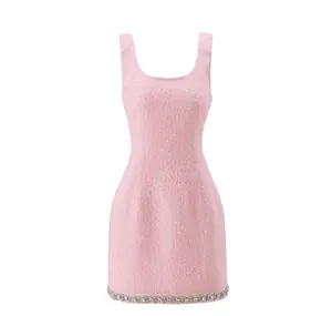 Elegant pink tweed sleeveless mini dress with sparkling crystal trim at the hem
