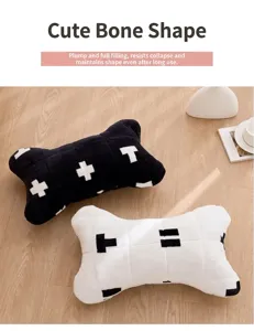 Primo piano di cuscini in peluche a forma di osso per animali in bianco e nero