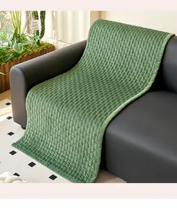 Detailed close-up view of a green ribbed corduroy sofa mat with textured fabric surface