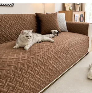 Detalle de funda de sofá de pana marrón con un gato descansando sobre tela tejida.