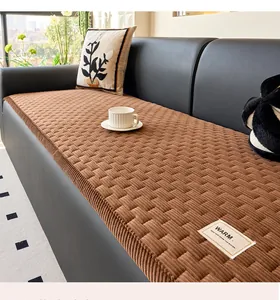 Detailed close-up of brown corduroy sofa mat with textured grid pattern and warm label