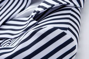 Primer plano que muestra la textura de la tela a rayas blancas y negras de un blazer de mujer