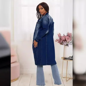 Side view of long distressed denim trench coat for women in deep blue wash