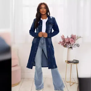 Full length detail of a women's distressed long denim trench coat in dark blue