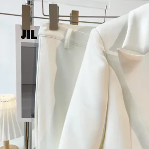 Detailed view of elegant snow white casual suit showing high-quality fabric and finish