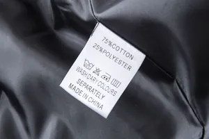 Detail of clothing care label showing 75% cotton and 25% polyester material composition
