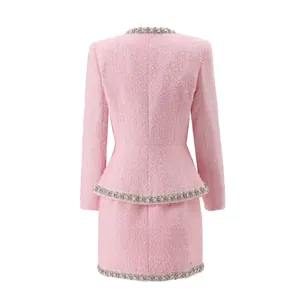 Elegant pink tweed two-piece set with crystal trim jacket and mini skirt back view.