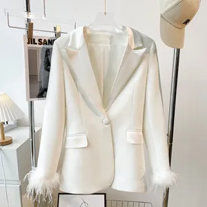 Elegant white blazer featuring stylish feather-trimmed cuffs and a single-button closure.