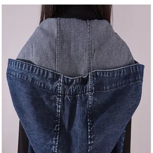 Close-up detail of a dark blue sleeveless hooded denim dress with stitching accents