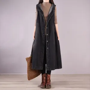 Detailed view of long sleeveless black denim dress with hood and button closure