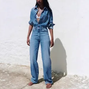 Full view of a stylish women's denim long-sleeved jumpsuit with lapel and pockets