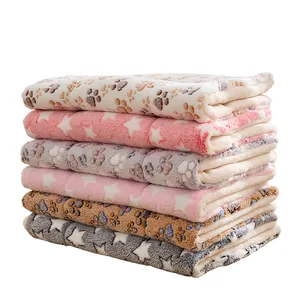 Pila de mantas suaves de felpa para mascotas con diseños de huellas y estrellas comfy