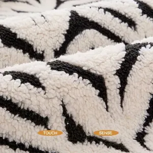 Close-up texture of soft black and white patterned warm plush pet blanket mat