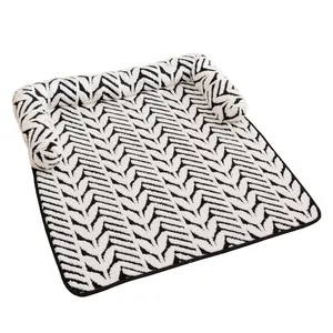 Plush pet blanket with black and white chevron pattern and raised bolsters for dogs and cats.