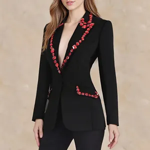 Detailed view of women's slim-fit luxury black blazer featuring vibrant red crystal beadwork