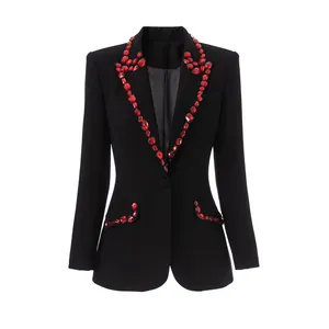 Close-up of black tailored blazer featuring luxury red crystal embellishments on lapels