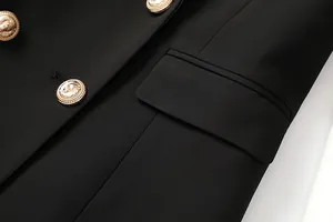 Detail of golden lion head buttons and flap pocket on a black double-breasted blazer