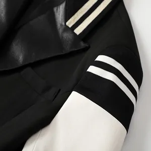 Close-up of stylish contrast leather sleeve blazer with black white stripes detail